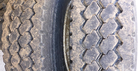 Inspecting tires on used trailers for sale at a Ritchie Bros. auction