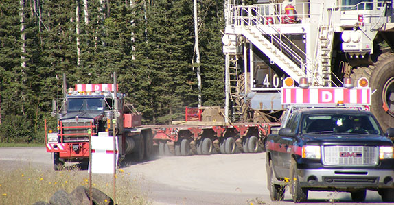 Heavy haul truck moves a large off-highway dump truck Heavy haul truck moves a large off-highway dump truck