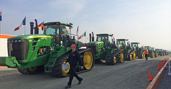 John Deere track farm tractors selling at a Ritchie Bros. equipment auction. John Deere track farm tractors selling at a Ritchie Bros. equipment auction.