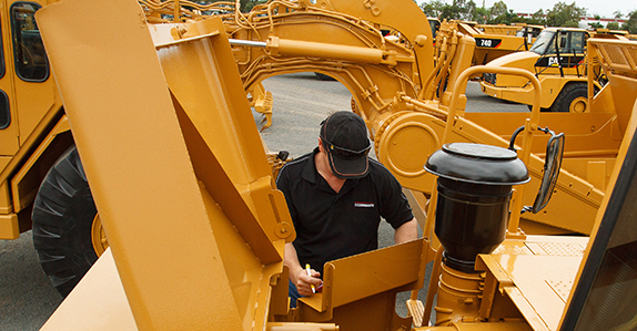 Inspecting heavy equipment for sale at Ritchie Bros.