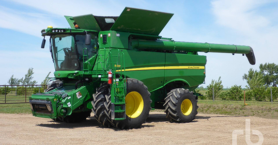 2015 John Deere S690 combine sold at a Ritchie Bros. farm equipment auction.