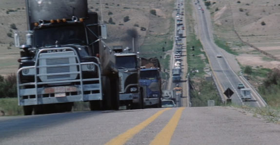 A Mack transport truck leads the convoy